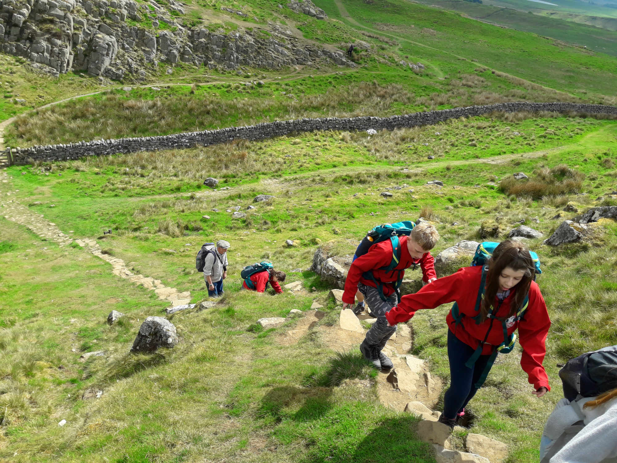 School children climbing hills