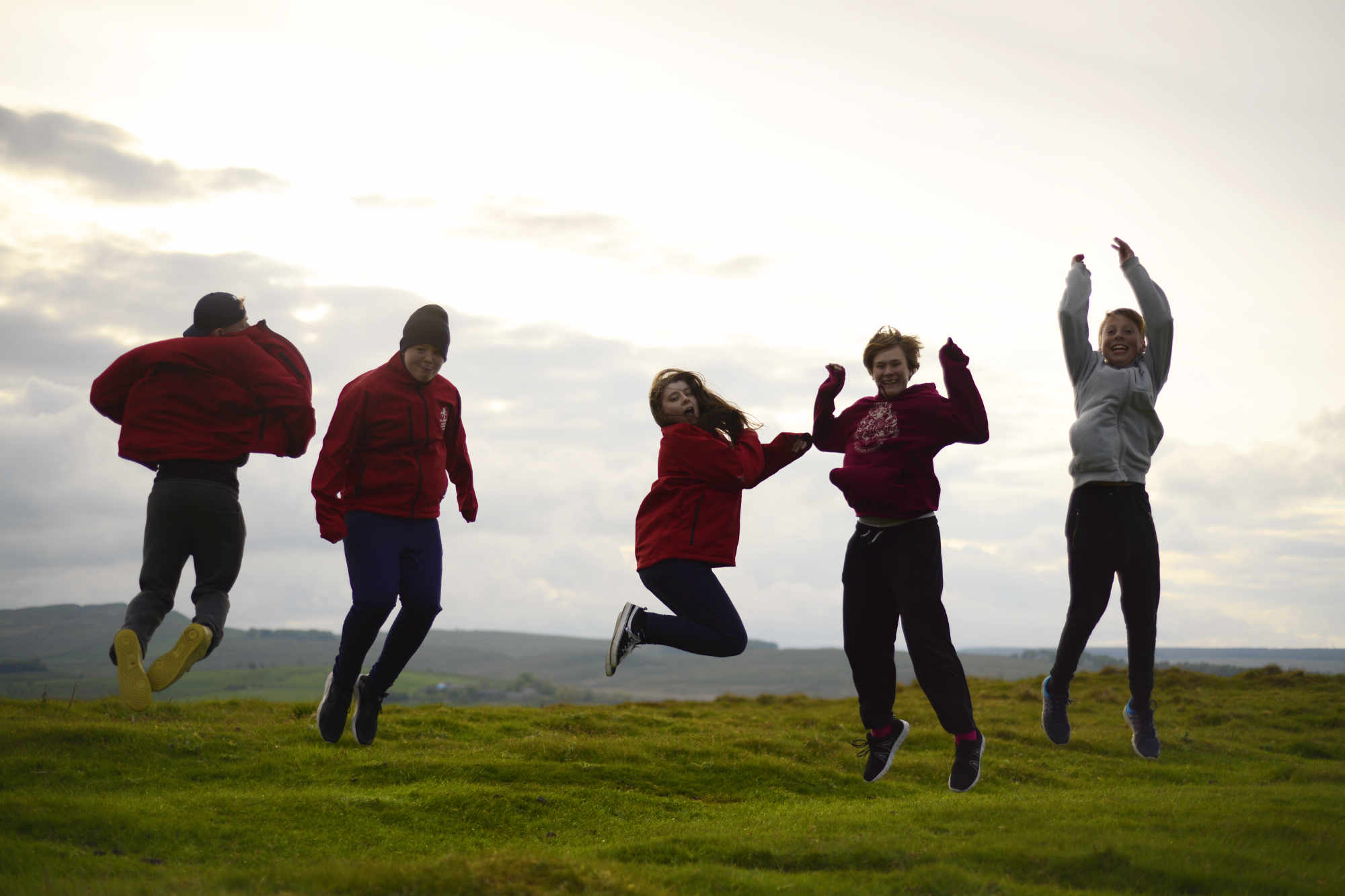 School group playing in a field