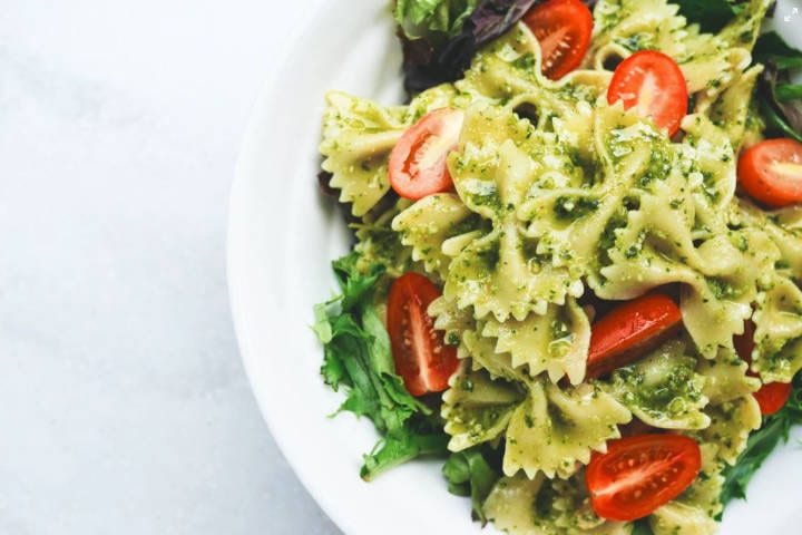 Pesto and tomato pasta in a bowl