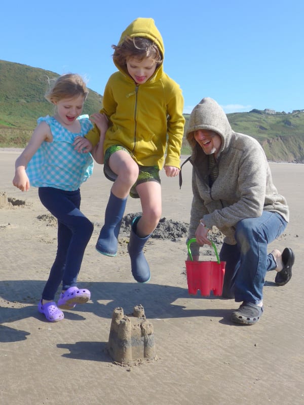Family building sandcastles on the beach