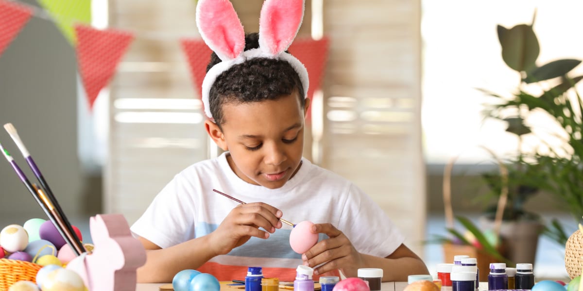 Child painting egg