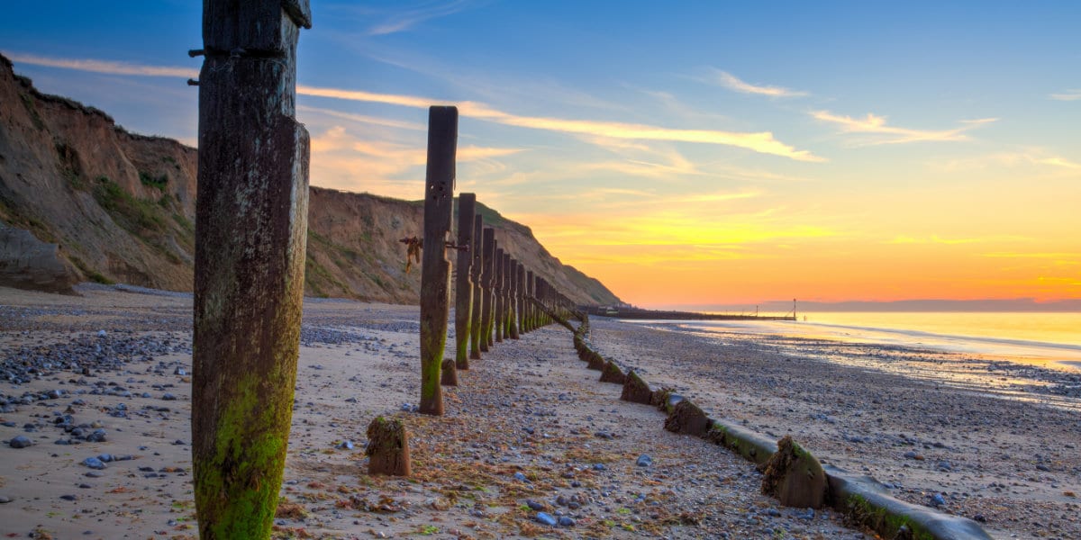 Sheringham beach and cliffs at sunset,,England