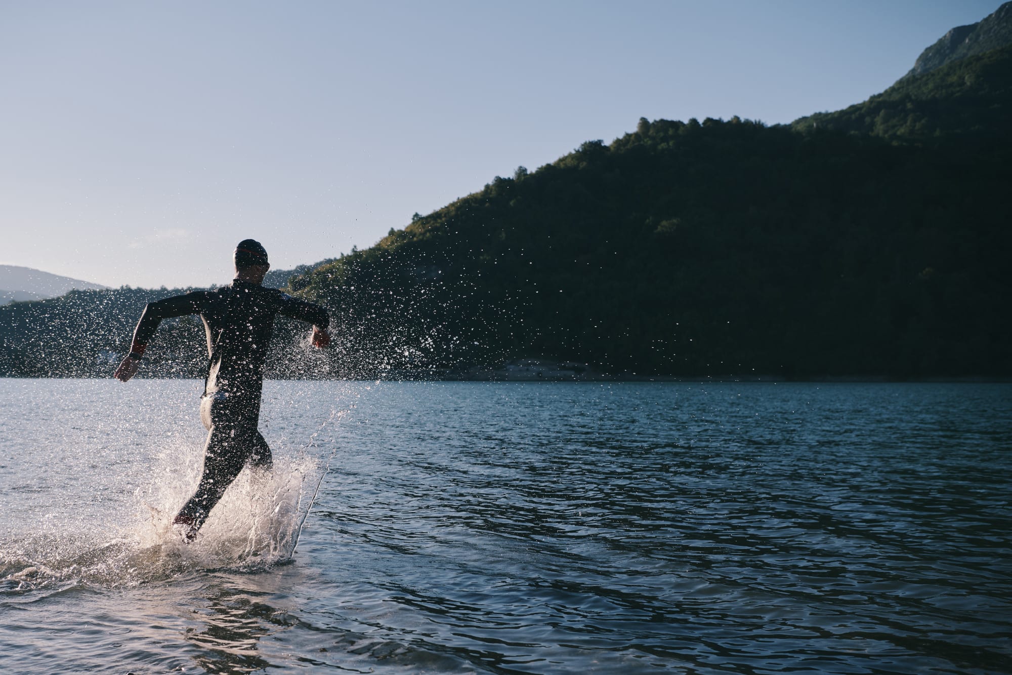 Athlete striding into lake