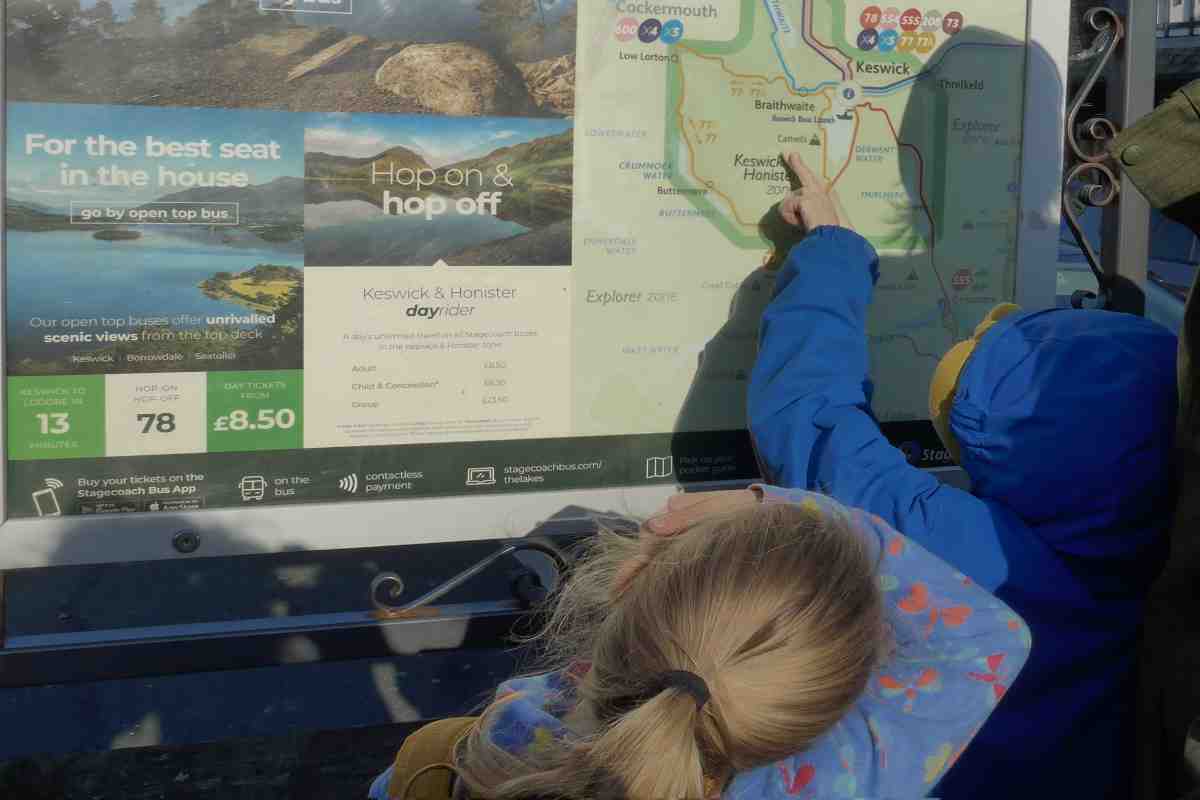 Two children looking at the bus timetable
