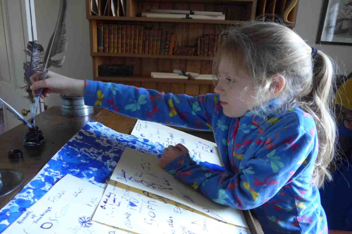 Young girl quill writing