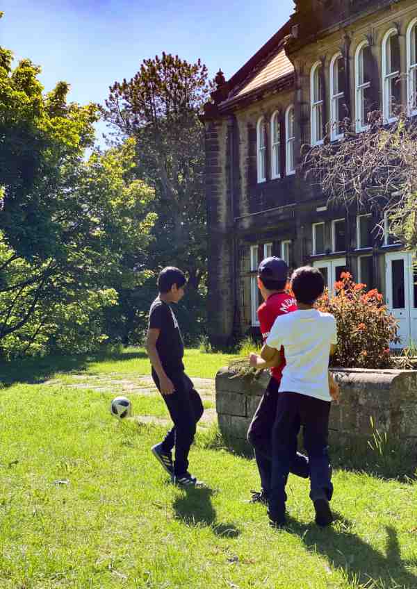 Group of boys playing football outside