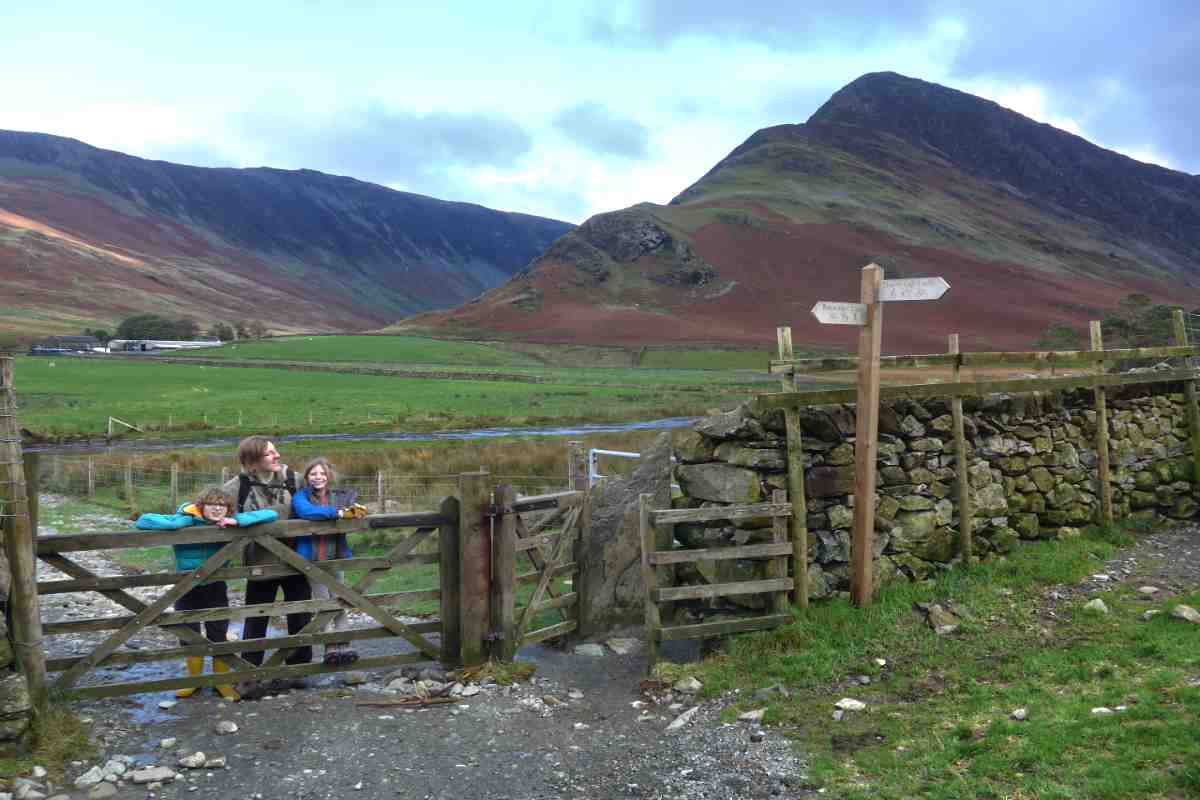 Man and children stood near a gate in the Lake District