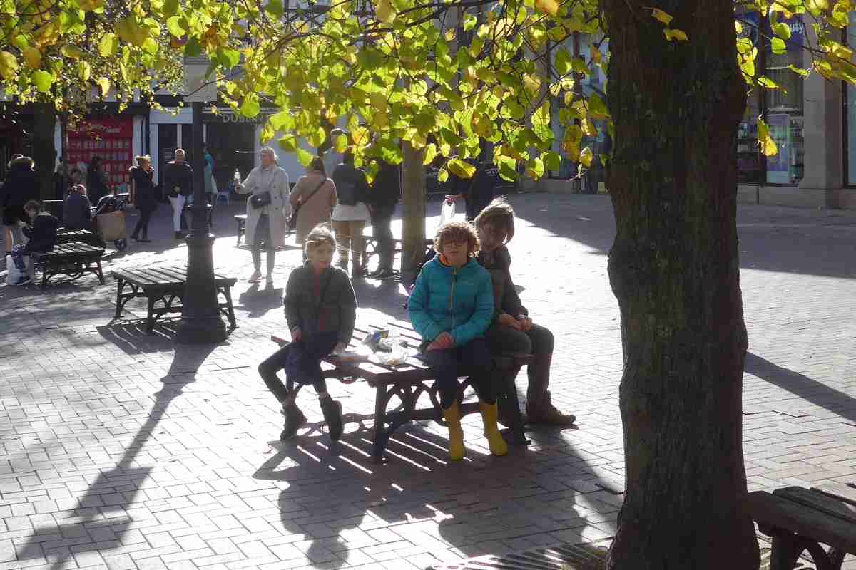 A family sat on a bench in Chester square