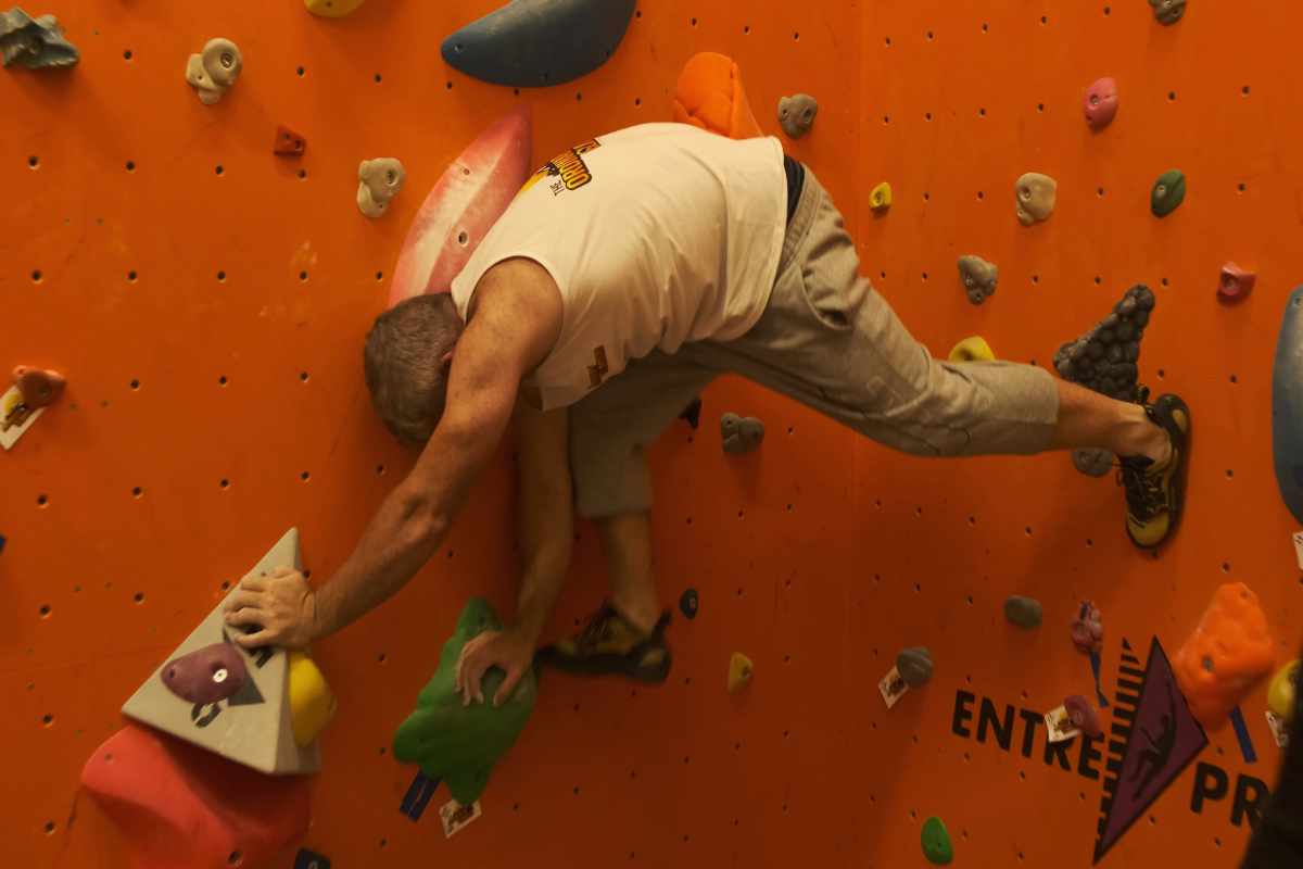 Man climbing up climbing wall