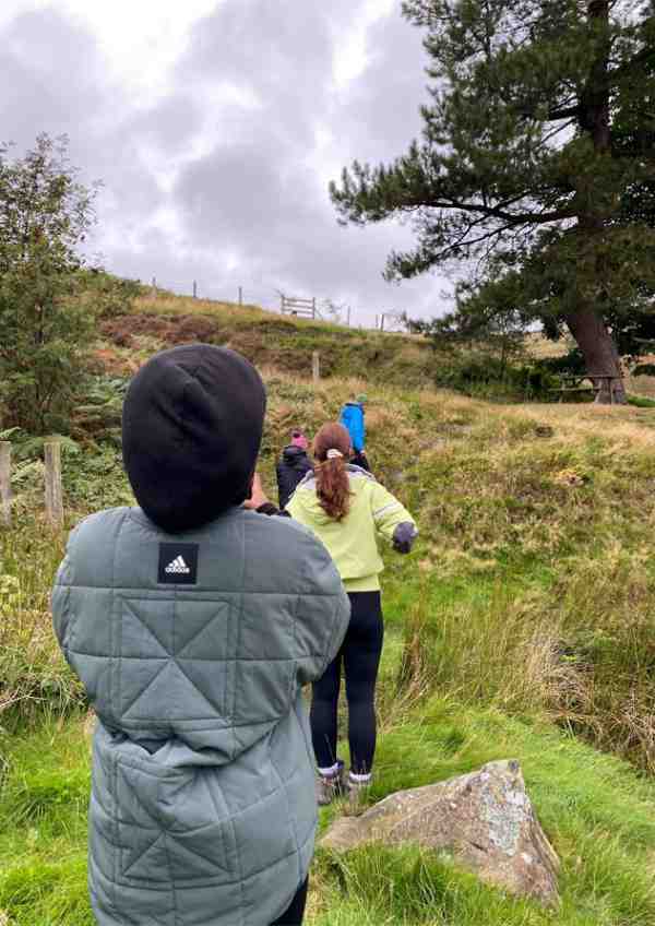 A group of young people walking up a hill