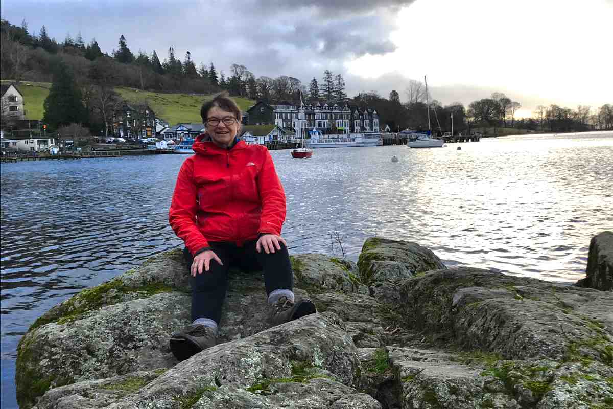 Woman sat on the shores of Lake Windermere