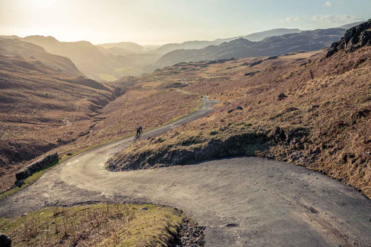 A man cycling down a track in the Lake District