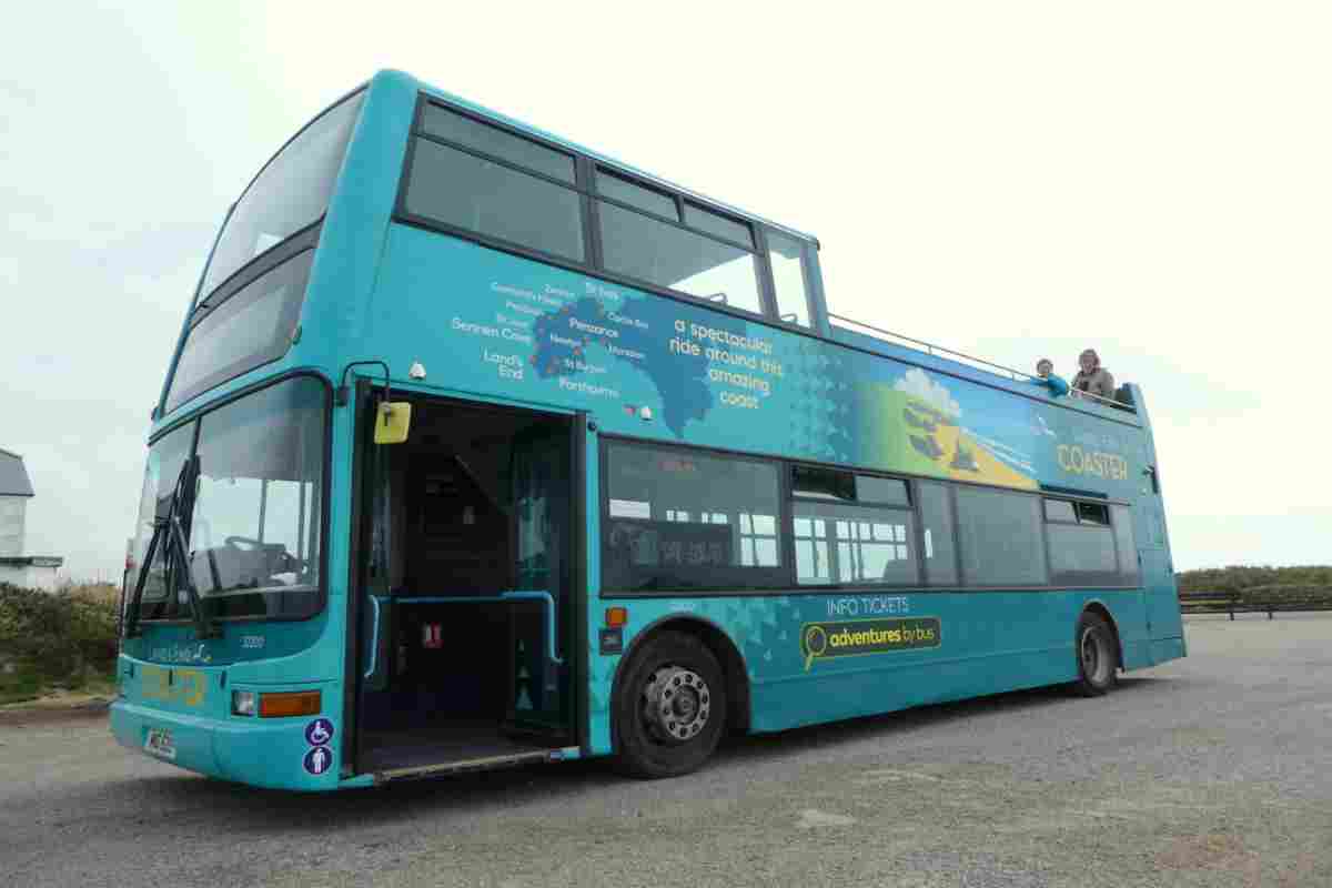 Father and daughter sat on an open top bus in Cornwall