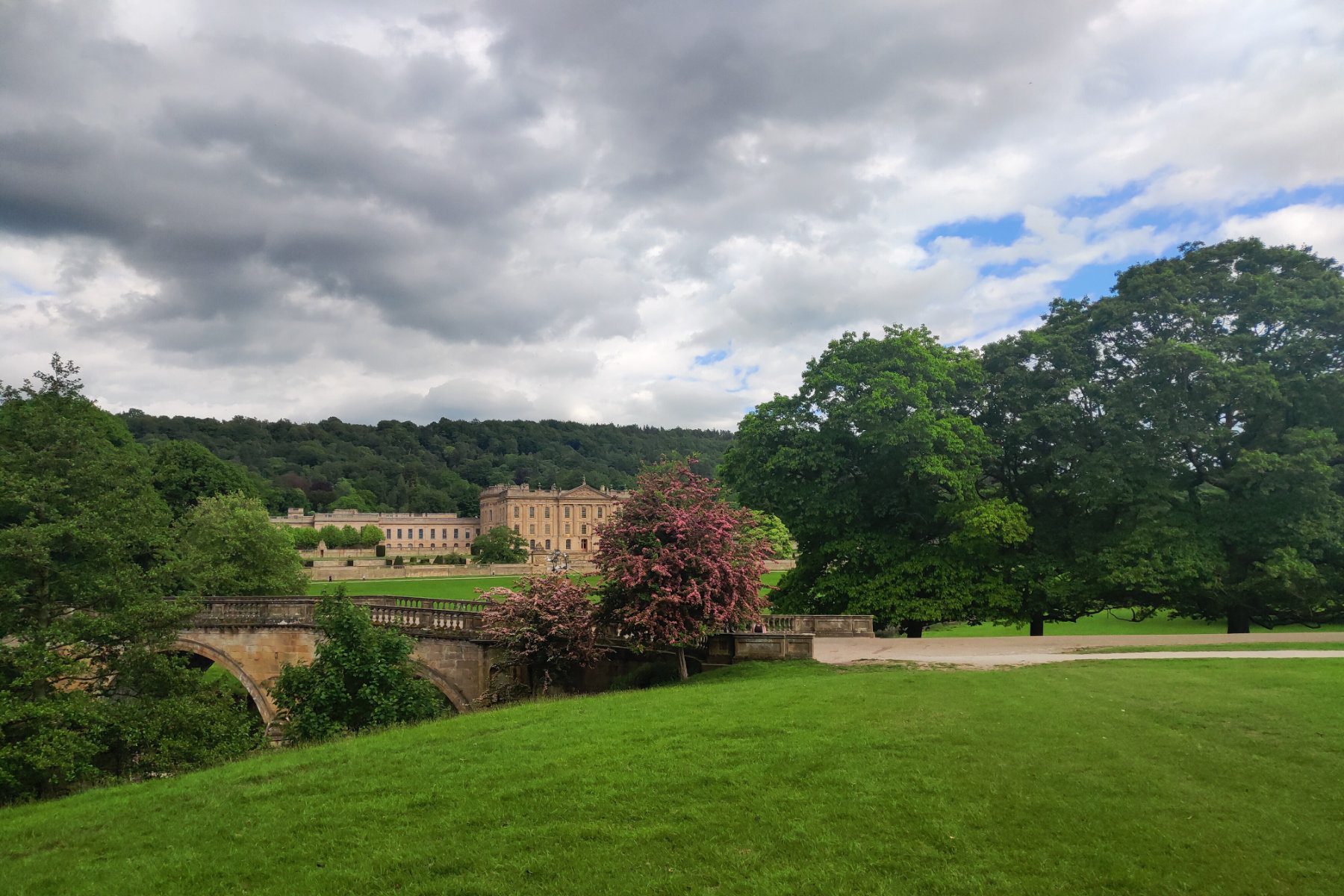 Chatsworth house in the distance of a landscape