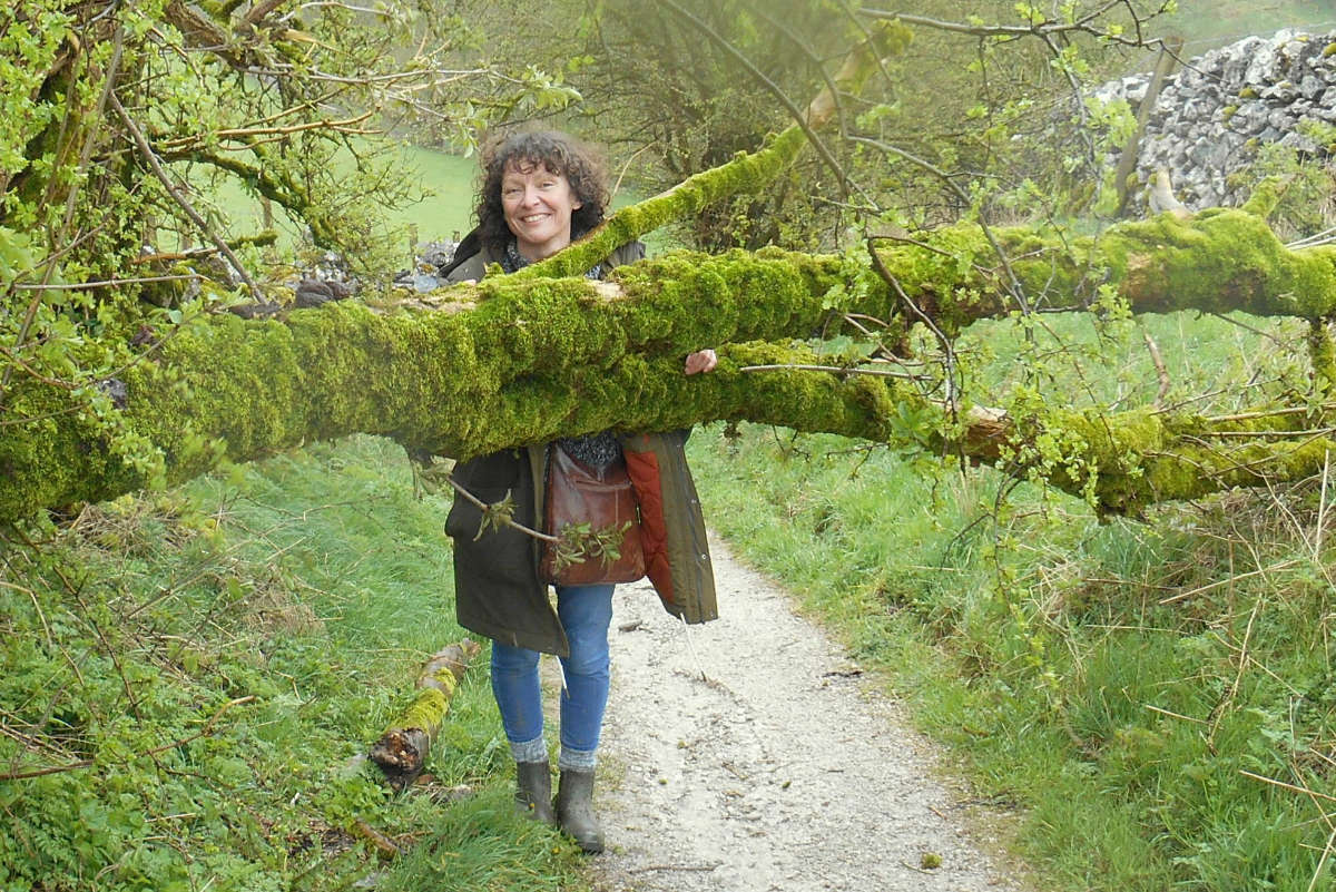 Jenny Lunnon leaning on a moss covered tree